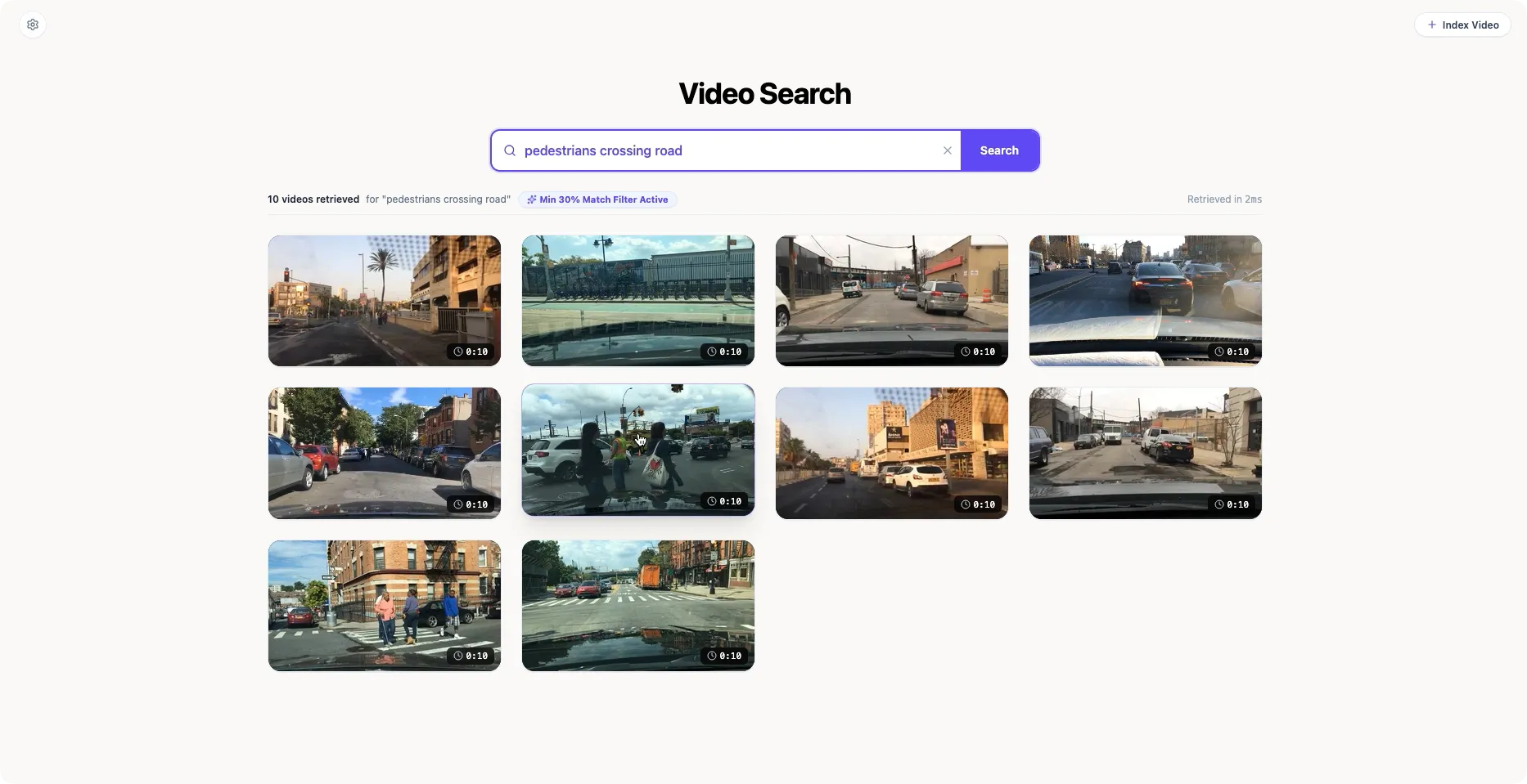 Video Search demo interface showing the query pedestrians crossing road and a grid of retrieved driving clips.
